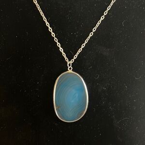 Handcrafted blue glass pendant on a 27 inch silver tone chain